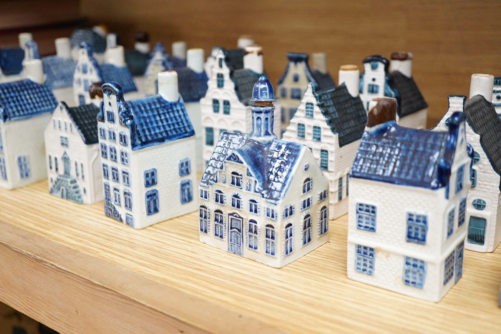 A collection of twenty seven KLM Delft blue miniature houses presented to Business class passengers together with a Delft jug - 20.5cm high